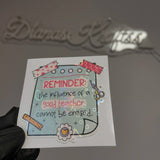 Sticker with motivational quote about a good teacher held by a gloved hand.