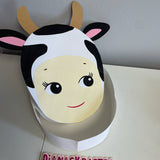 Cow-themed paper mask on a white surface with 'Dianaskrafts' branding.
