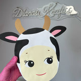 Cow face mask held by a hand with pink glove against a gray background with 'Dianas Krafts' branding.